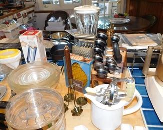 kitchen packed with cookware, kitchen gadgets, cook books, small appliances, pots and pans