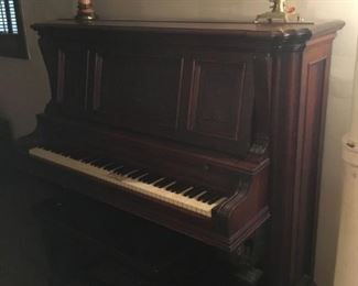 beautifully carved upright piano