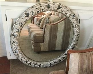 Round wall mirror in cast metal