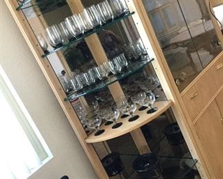 End cabinet or corner unit, shown with light off, large set vintage stemware, Hall baking dishes