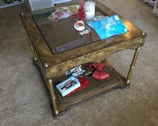 End table matches one of the coffee tables with brass legs and caned shelf