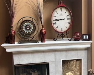 The clock is a reproduction of an old French clock, metal and sitting on a very large easel.  It's hard to get the scale of these items.  The clock itself is about 28" tall, plus the easel.