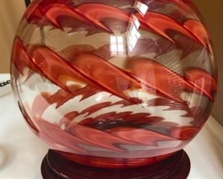 Such a pretty piece of art glass, made into a rose bowl or vase. Sits on a wooden base.