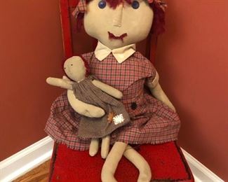Oh this is so sweet - a little possibly antique child chair, a folk art doll and her doll. !