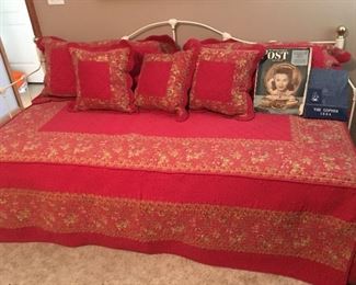Day bed with pretty quilt and matching pillows