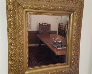 Vintage wall mirror in ornately carved (gold) wood frame.  25" x 28"
