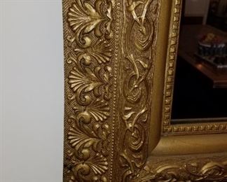 Vintage wall mirror in ornately carved (gold) wood frame.  25" x 28"