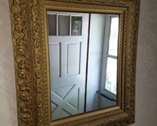 Wall mirror, ornate carved wood (gold) frame.  28" x 31"