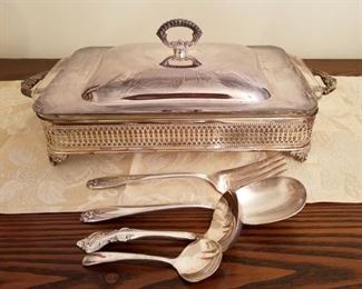 Silver plated rectangular server with Pyrex glass insert, silver plated serving spoons, ladle and fork.