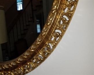 Vintage oval wall mirror in ornate frame.  23" x 31"