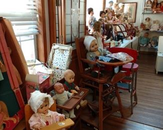 Dolls in highchairs and dolls in carriers