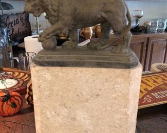 Bronze lion statue on marble base