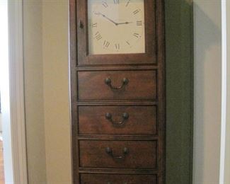 Tall clock with storage.