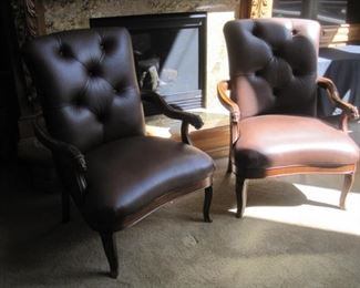 A pair of newly reupholstered leather armchairs.
