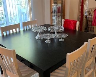 Large square black table and 8 white chairs, crystal pie plates