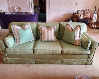 Green upholstered sofa w/decorative cording