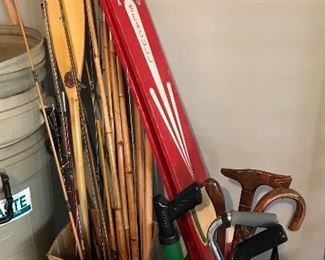 Fishing poles, vintage wooden water skiis, canes