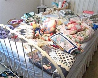 Contemporary queen size iron bed style and a bunch of quilts