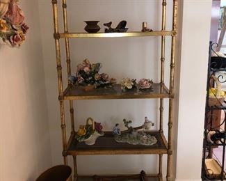 Gilt metal shelving unit with glass shelves