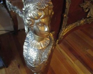 Brass adornment on desk leg.