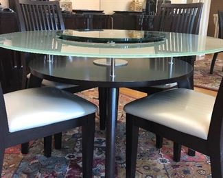 Modern Round glass topped table - 48" with center that raises and has a lower tier also - with 4 chairs -