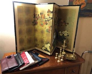Leather purses, Asian screen and brass candle holders
