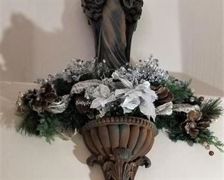 Fabulous artifact looking angels along with wall urns and florals.