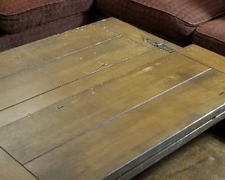 Wooden and metal coffee table that opens up on both sides.