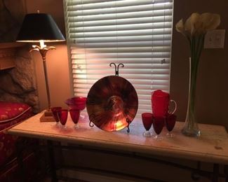Sofa table, lamp, red glassware