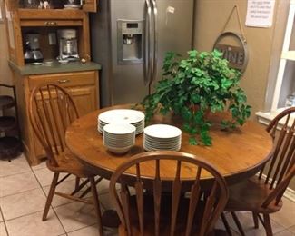 Round oak breakfast table, GE stainless steel refrigerator