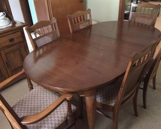 Pecan table and 6 chairs (two are captain chairs.  Also have the table pads.