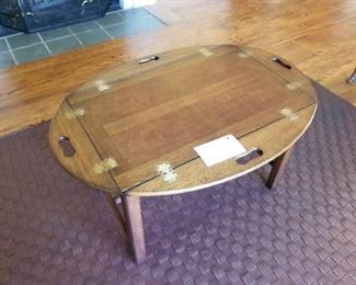 Butlers coffee table on brown leather woven rug. 