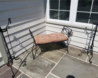 Wrought iron bench and tall plant stands 