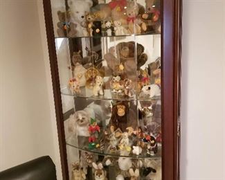 Lovely lighted curio cabinet and Steiff collection 