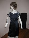 A hot little two piece vintage little balck suit! It has lace sleeves and front teaser piece with a seperate jacket that is fitted and flirty!!