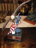 This eagle is sitting on a book with a police badge, and hat!!