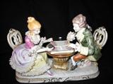 This is my favorite piece!! As an avid backgammon player this figurine of a man and woman in colonial garb playing backgammon! This vintage piece is by KPM