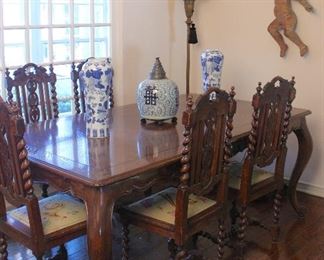 French Country-style dining table with end leaves; antique carved wood cherub.