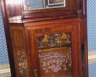 Turn of the last century china cabinet filled with Waterford crystal