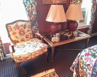 FLORAL ARM CHAIR, GOLD AND GLASS COFFEE TABLE