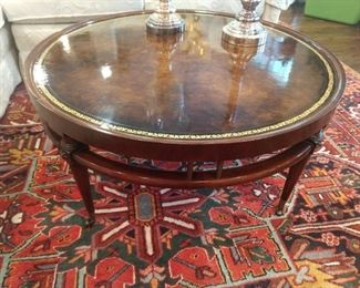 Vintage round mahogany coffee table, with tooled leather top, by Weimann Furn. Co., High Point, NC.