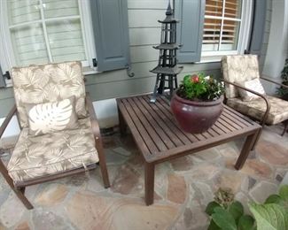 One of two pair of metal outdoor armchairs, with Sunbrella fabric cushions. 