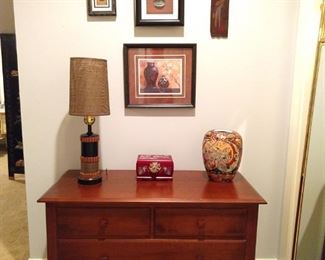 Nice vintage mahogany chest, with found art from all of her worldly travels.