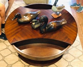 This is the coolest coffee table. Hide your remotes or whatever by just a turn..
