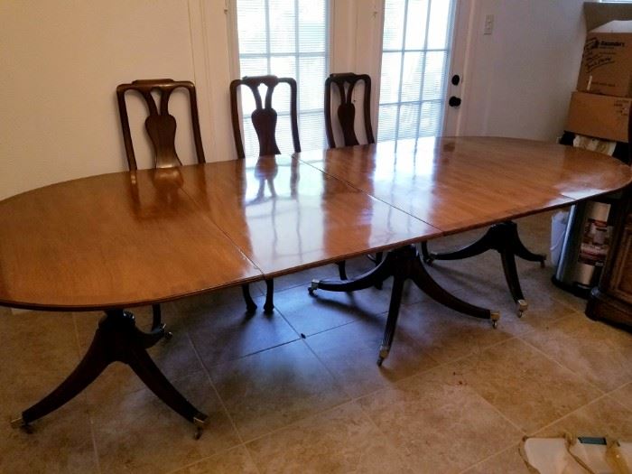 HUGE wooden table with 3 leafs and 11 chairs. Can seat 16