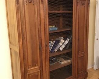 French Louis XVI style bookcase with wire front doors. 67”W x 81”H x 18”D