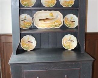 Great step back cabinet shown with Limoge fish plates. 