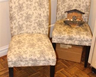 Parson chairs shown with a coo coo clock.  