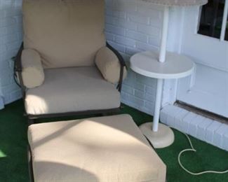Woodard chair and ottoman with outdoor lamp.