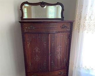Victorian sheet music cabinet with beveled glass mirror. Inlayed with mother of pearl and brass and silver